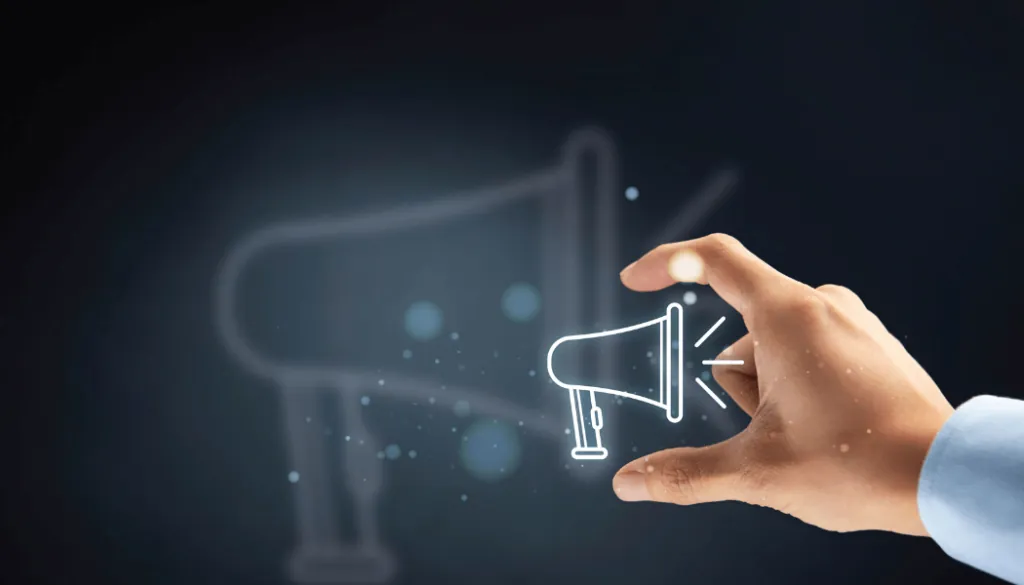 Man holding a lit-up-icon of a megaphone